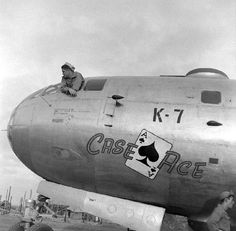 a man sitting on the nose of an airplane