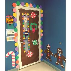 a door decorated with candy and decorations in a room that is blue, white, and green