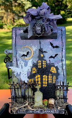 a halloween card holder made out of paper with bats and tombstones on the front