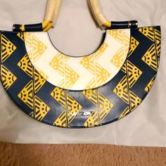 Brand New, Unused Sassy Jones Vanessa Handbag In Blue And White. It's Leather With Suede Leather Interior. Shoulder Strap And Handles Are Still Wrapped In Tag Is Attached. Poshmark Takes 20%. Yellow Top Handle Shoulder Bag For Vacation, Yellow Crossbody Shoulder Bag For Day Out, Yellow Tote Bag For Day Out, Yellow Tote Bags For Day Out, Yellow Retro Shoulder Bag For Shopping, Retro Yellow Shoulder Bag For Shopping, Sassy Jones, Aldo Purses, Louis Vuitton Speedy 40