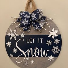 a sign that says let it snow hanging on the wall