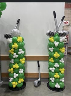 two golf themed lawn decorations in the shape of balls and tees, with forks on them