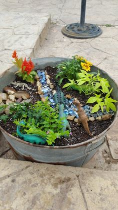 a potted planter filled with lots of different types of plants and animals in it