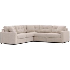 a beige sectional couch with pillows on the top and bottom corner, facing away from the camera