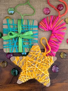 some crafting supplies are laying out on a wooden surface and tied together with ribbons