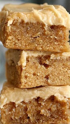 three pieces of peanut butter bars stacked on top of each other with one bite taken out