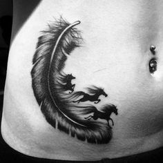 a black and white photo of a woman's stomach with a feather tattoo on it