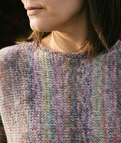 a close up of a woman wearing a sweater