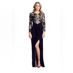 This Black David Meister Gown Combines A Lace Top With A Slinky Skirt For Alluring Sophistication Under The Stars. The Diagonal Pleating At The Waist Adds An Element Of Interest And Luxury. The Sheer Black Lace Is Backed With Nude Lining, Keeping Your Modesty Intact. Features A Hidden Zip At The Back And Full Length Sleeves. Round Illusion Neckline Column Silhouette; Diagonal Pleats At Waist Illusion Gown, Full Length Skirts, Illusion Neckline, Under The Stars, Black Tan, Black Tie, Mother Of The Bride, Black Lace, The Bride