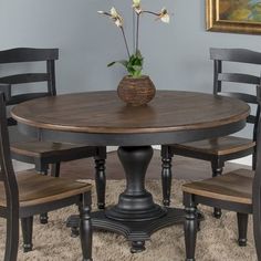 a round table with four chairs around it