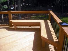 a wooden bench sitting on top of a wooden deck