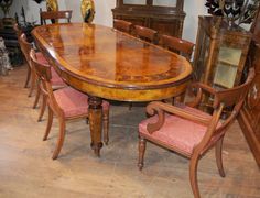 a dining room table with chairs and a mirror on the wall in front of it