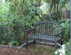 a wooden bench sitting in the middle of a forest