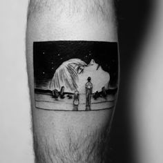 a man's leg with a black and white photo of two people standing in front of a polar bear