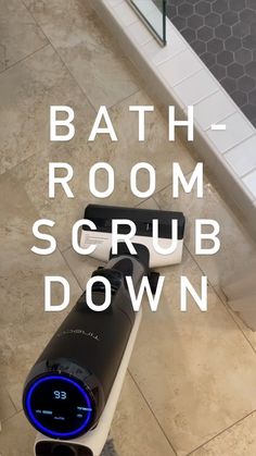 a bath room scrub down sign on the floor in front of a tiled bathroom area