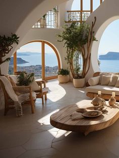 a living room filled with lots of furniture next to an arched window overlooking the ocean