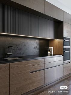 a modern kitchen with wooden cabinets and black counter tops, along with an oven on the wall