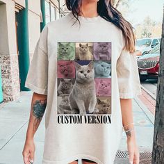 a woman standing next to a tree wearing a t - shirt with cats on it