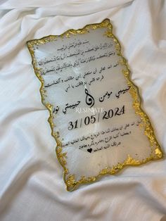 a white sheet with gold writing on it