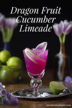 the dragon fruit cucumber limeade is garnished with sliced lemons