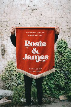 a person holding up a sign that says rose and james