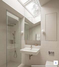 a bathroom with a skylight above the sink