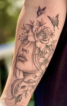 a woman's face with flowers and butterflies on her arm