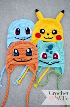 three crocheted hats with eyes and ears on top of each other, one has a