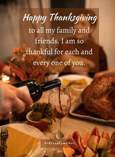 a person pouring wine into a glass on top of a table with turkey and oranges