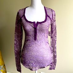 a mannequin wearing a purple top with lace