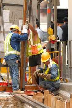 construction workers working on the side of a building under construction stock images and royalty photos