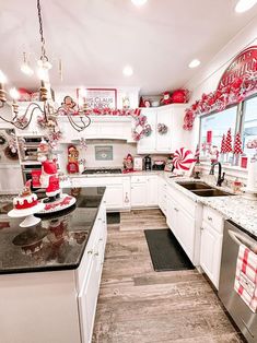 a kitchen decorated for christmas with red and white decorations