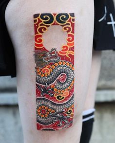 a person with a dragon tattoo on their arm