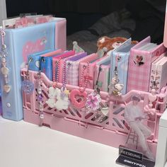 there is a pink and blue display with jewelry on it