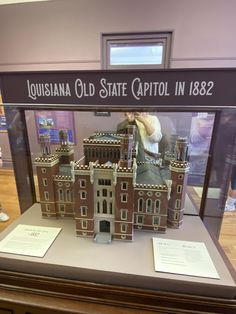 a model of the old state capitol building is on display in a glass case with information about it