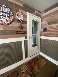 a room with wooden paneling and various signs on the wall, including an american flag