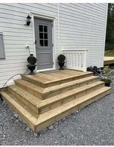 the steps are made out of wood and have planters on them