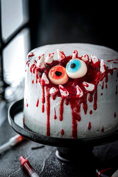 a decorated cake with eyes and blood on it