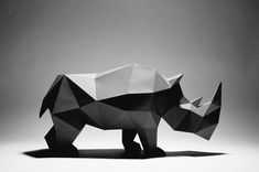 an origami rhinoceros is shown in this black and white photo with low lighting