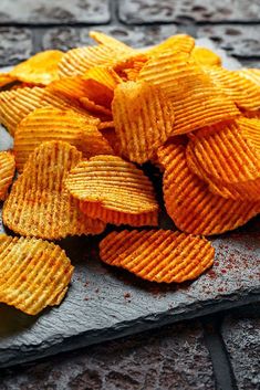 a pile of potato chips sitting on top of a stone slab