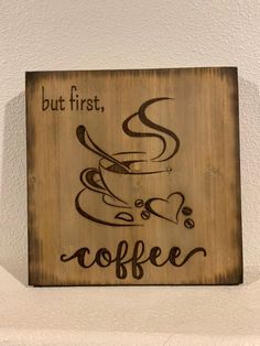 a wooden sign that says but first, coffee with a cup of coffee on it