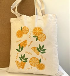 a white bag with oranges painted on it