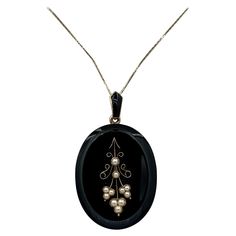 This is a magnificent Victorian - Belle Epoque Picture locket pendant necklace in Black Onyx, and 14 Karat Gold with Pearl adornments in a Flower Motif design with an exquisite braided hair checkerboard design on the reverse. This is one of the most stunning Victorian lockets we have seen. The locket is an oval locket in Black Onyx with a flower motif set with pearls in 14 Karat Yellow Gold. The bale is decorated with black Enamel. The reverse of the locket has a wonderful compartment which has an extraordinary braided hair design which opens for you to place your treasured photo. The locket is absolutely exquisite with classic Victorian design. I love the elegance and simplicity of this locket. The black onyx feels wonderful in the hand with its sleek smooth texture and lovely scalloped b Luxury Antique Locket Jewelry, Pearl Locket, Victorian Locket, Picture Locket, Oval Locket, Locket Pendant Necklace, Necklace Flower, Victorian Design, Braided Hair