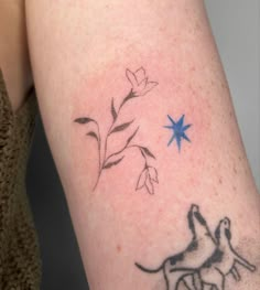 a tattoo on the arm of a woman with a dog and flower in front of her