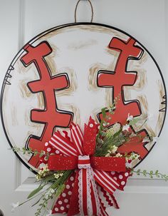 a red and white bow hanging from the side of a door with chinese characters on it