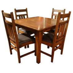 a wooden table with four chairs around it