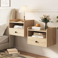 a wooden shelf with two drawers on it next to a white couch and a lamp