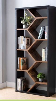 a book shelf with books and plants on it