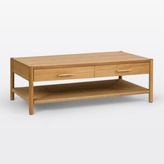 an oak coffee table with two drawers on one side and a shelf underneath the top