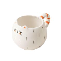 a white ceramic cat mug with orange stripes